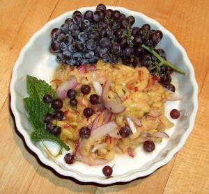 Green Peach Salad Green peach salad with garnish of mint and champagn grapes